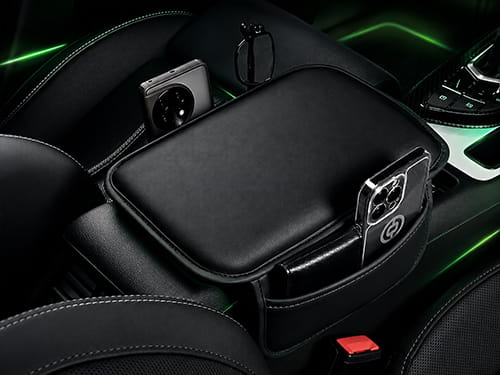 Center console armrest booster pad with storage pocket in a car